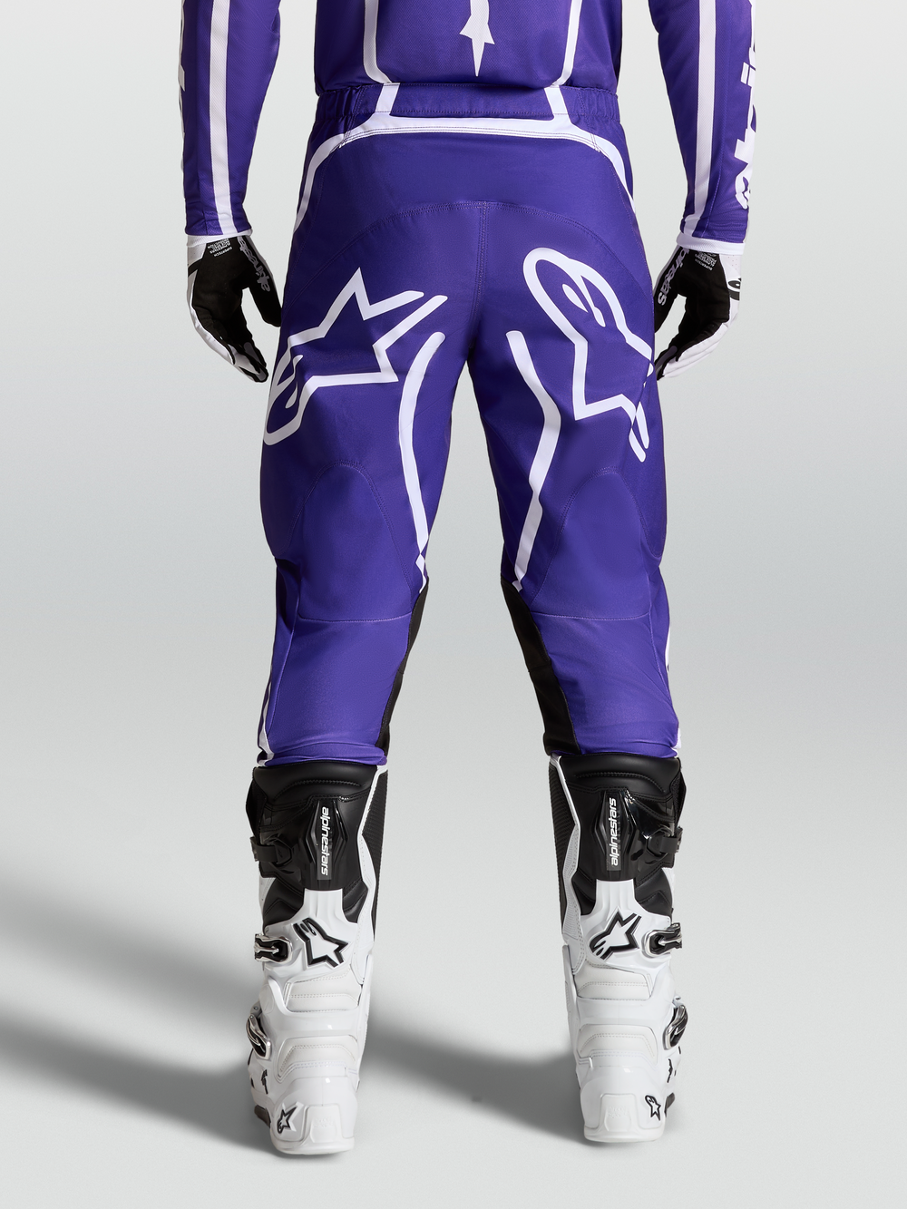 Alpinestars Fluid Apex V2 Pants, Men's Motocross and Off-Road Riding Pants, Deep Blue and White, durable 600D polyfabric and pre-curved leg design shown from the rear on model with boots.