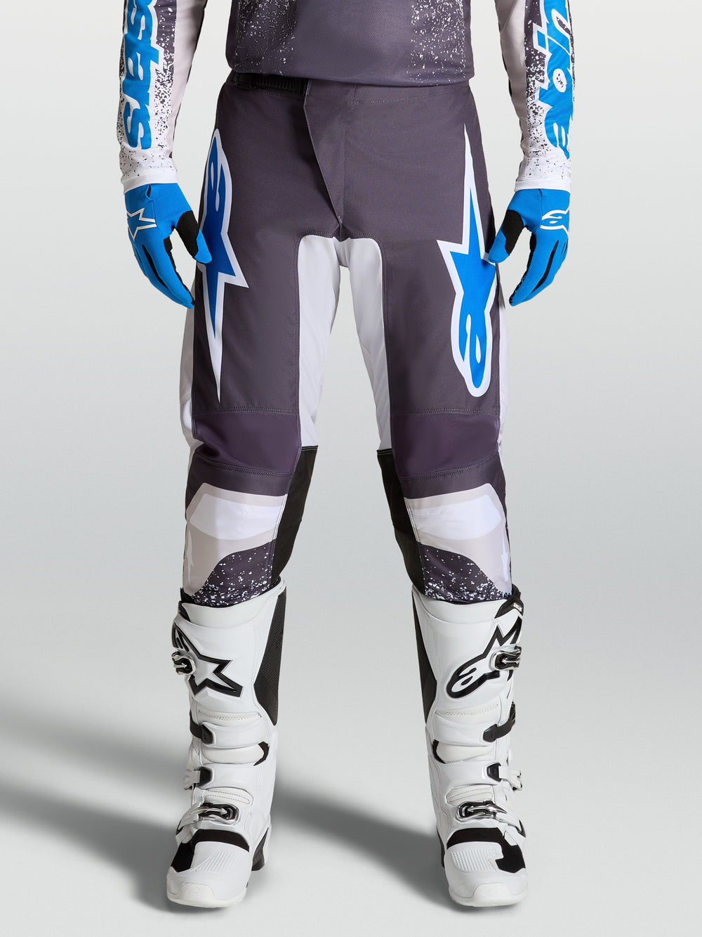 Alpinestars Fluid Drag Pants for motocross, Graystone and Ucla Blue, with pre-curved legs and ergonomic polyfabric protection.