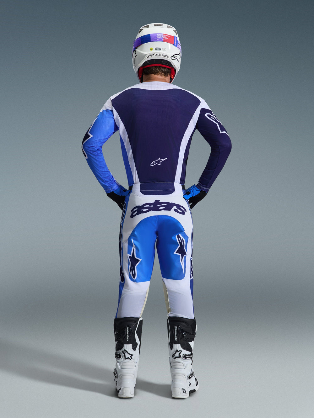 Alpinestars 2026 Racer Air Portl Pants, Motocross Pants, Ucla Blue White, rear view of rider wearing matching gear, white helmet, and white and black boots, featuring 