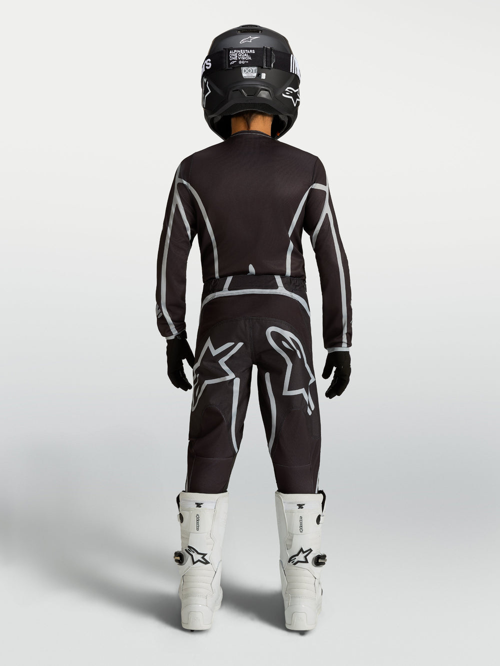 Alpinestars Youth Fluid Apex V2 Pants, black and silver youth MX pants with ergonomic riding fit, shown from the rear.