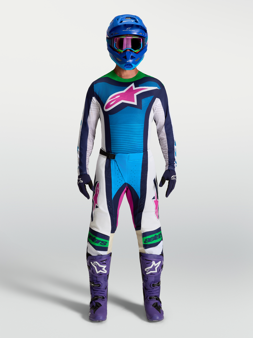 Alpinestars Techstar Maven Jersey, blue and white motocross race gear with pink accents and purple boots on model.