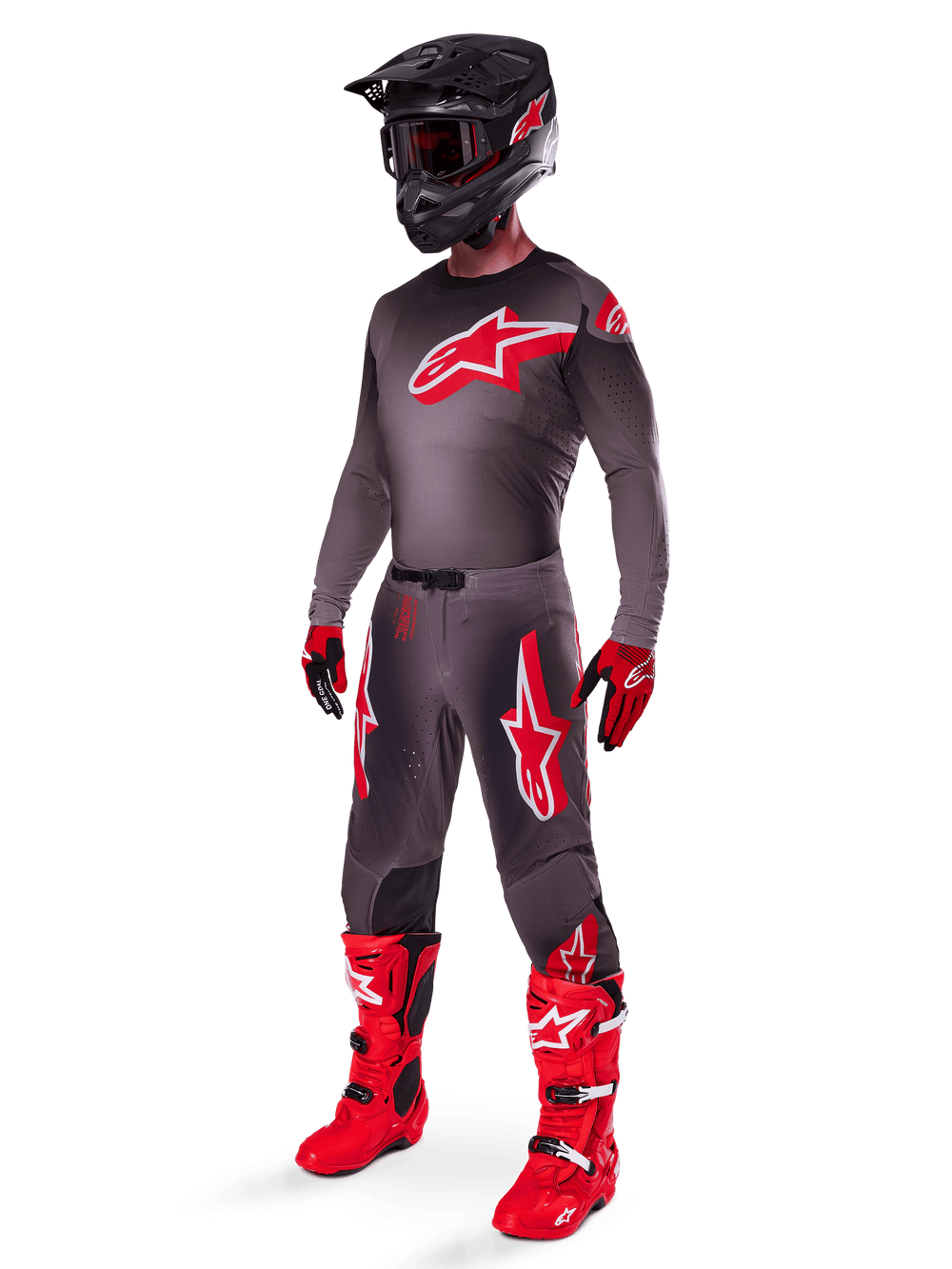 Motocross rider wearing complete racing gear, Smoke Bright Red 2025 Supertech Lipan Jersey, matching grey pants with red graphics, black helmet with red accents, bright red boots, and red and black gloves, coordinated professional outfit for off-road racing