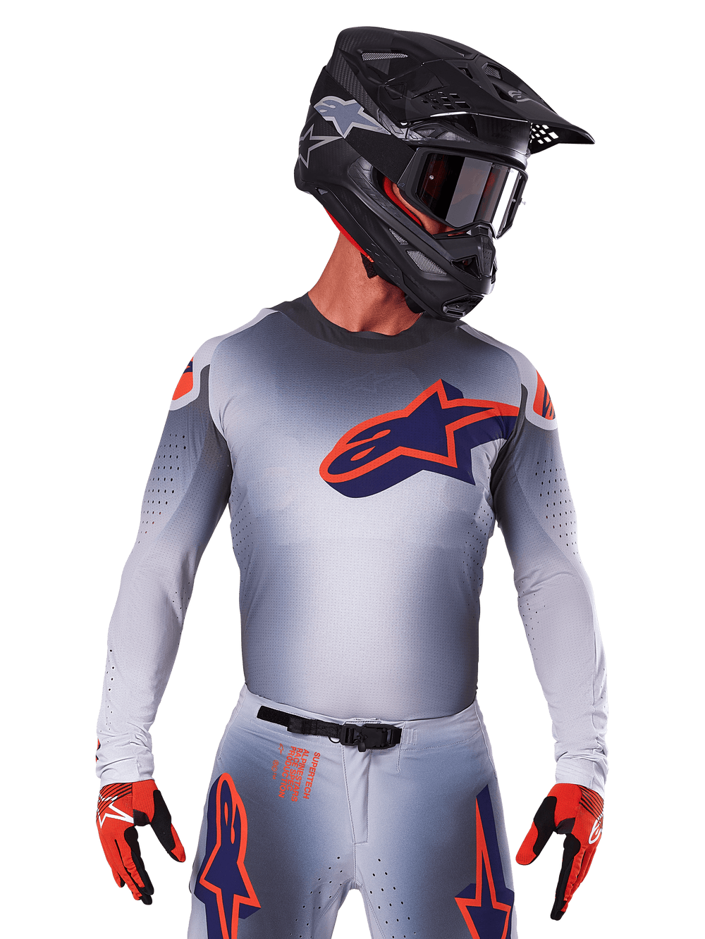 2025 Supertech Lipan Jersey, Motocross Racing Jersey, Gray with Orange and Navy Blue accents, long-sleeve performance top with perforated ventilation details, worn with black helmet and red gloves, sleek racing design