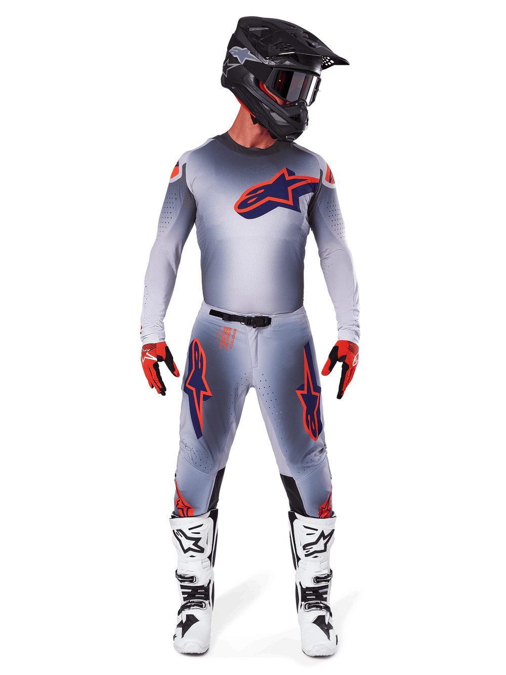 Motocross rider wearing the Alpinestars 2025 Supertech Lipan Jersey in Gray Orange Fluo, featuring a gray gradient design and orange logo, paired with matching motocross pants, black helmet, white boots, and orange gloves, coordinated pro-level racing gear.