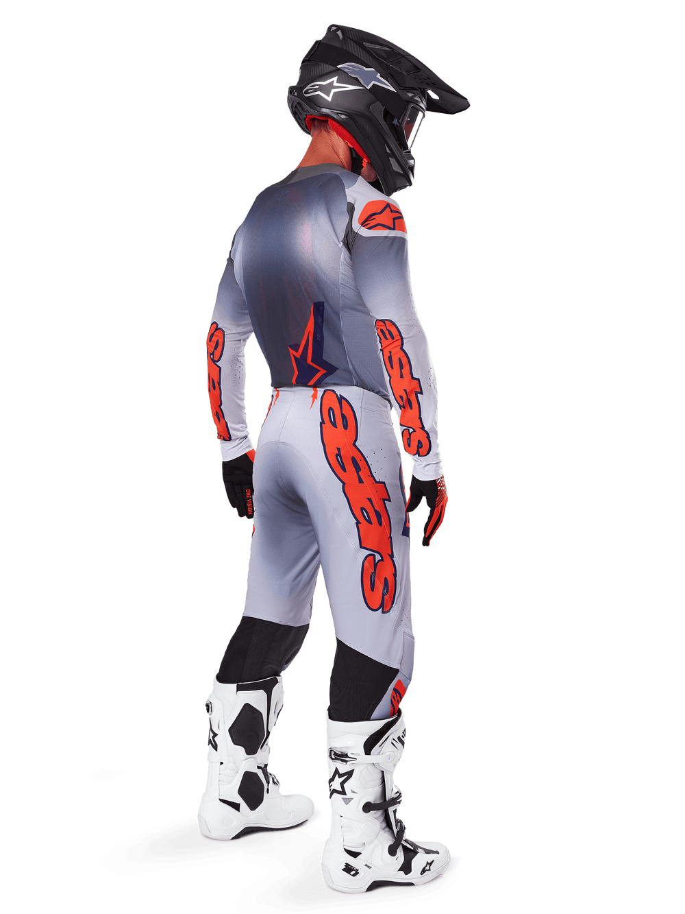 Motocross rider from a back-side profile wearing 2025 Supertech Lipan Jersey and matching pants in Gray and Orange Fluo, featuring bold orange Alpinestars branding on the sleeves and legs, paired with a black helmet and white boots, coordinated pro-level outfit for off-road racing