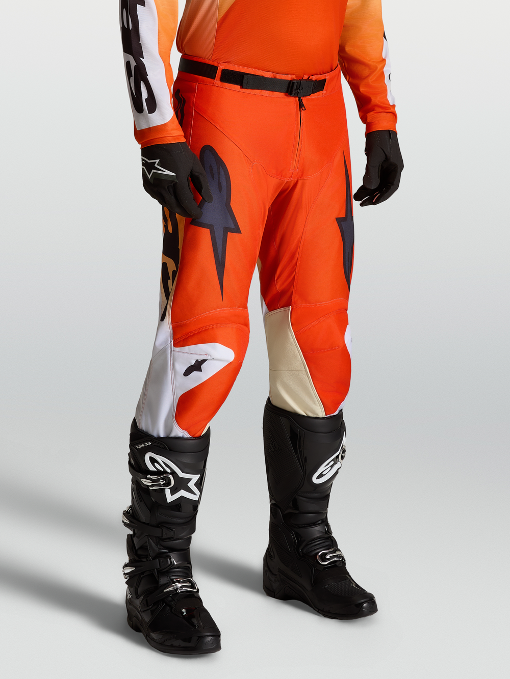 Alpinestars Racer Amber Pants, Men's Motocross Pants in Cardinal Red and Black, featuring a lightweight 600D polyfabric race fit on-model with matching racing jersey, gloves, and Tech Series boots.