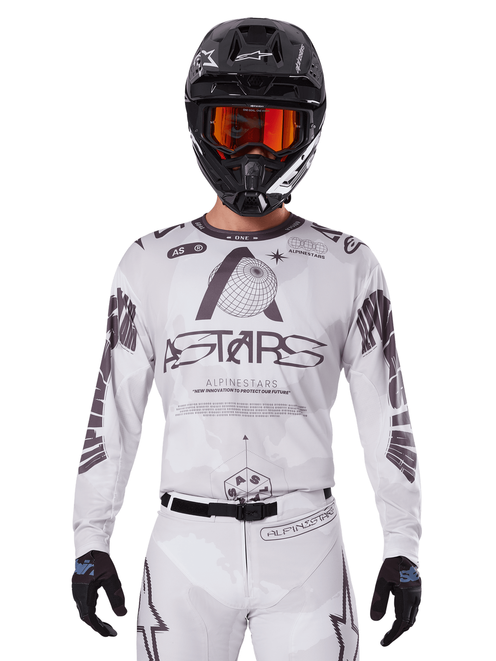 Alpinestars 2025 Racer Hollow Jersey, Motocross Jersey, White and Black, worn with matching white MX pants and a black helmet with orange goggles, featuring bold Alpinestars branding and globe graphics, professional off-road racing gear