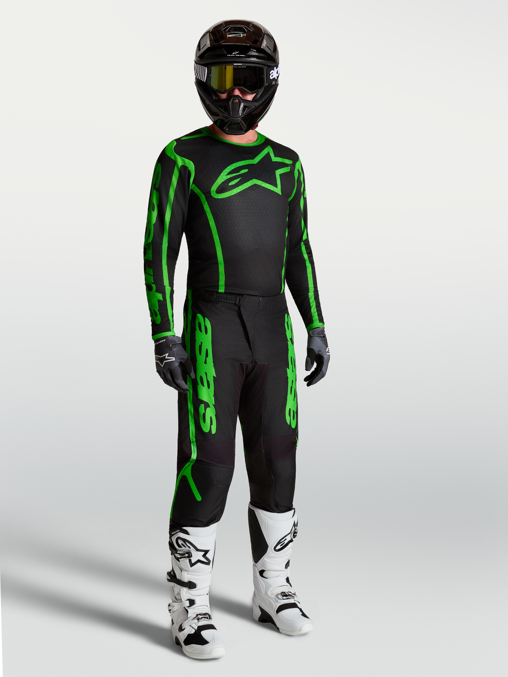 Alpinestars Fluid Apex V2 Pants, Men's Motocross Racing Gear, Black and Green Fluo, durable polyfabric with ergonomic fit, shown as a full gear set with white boots.