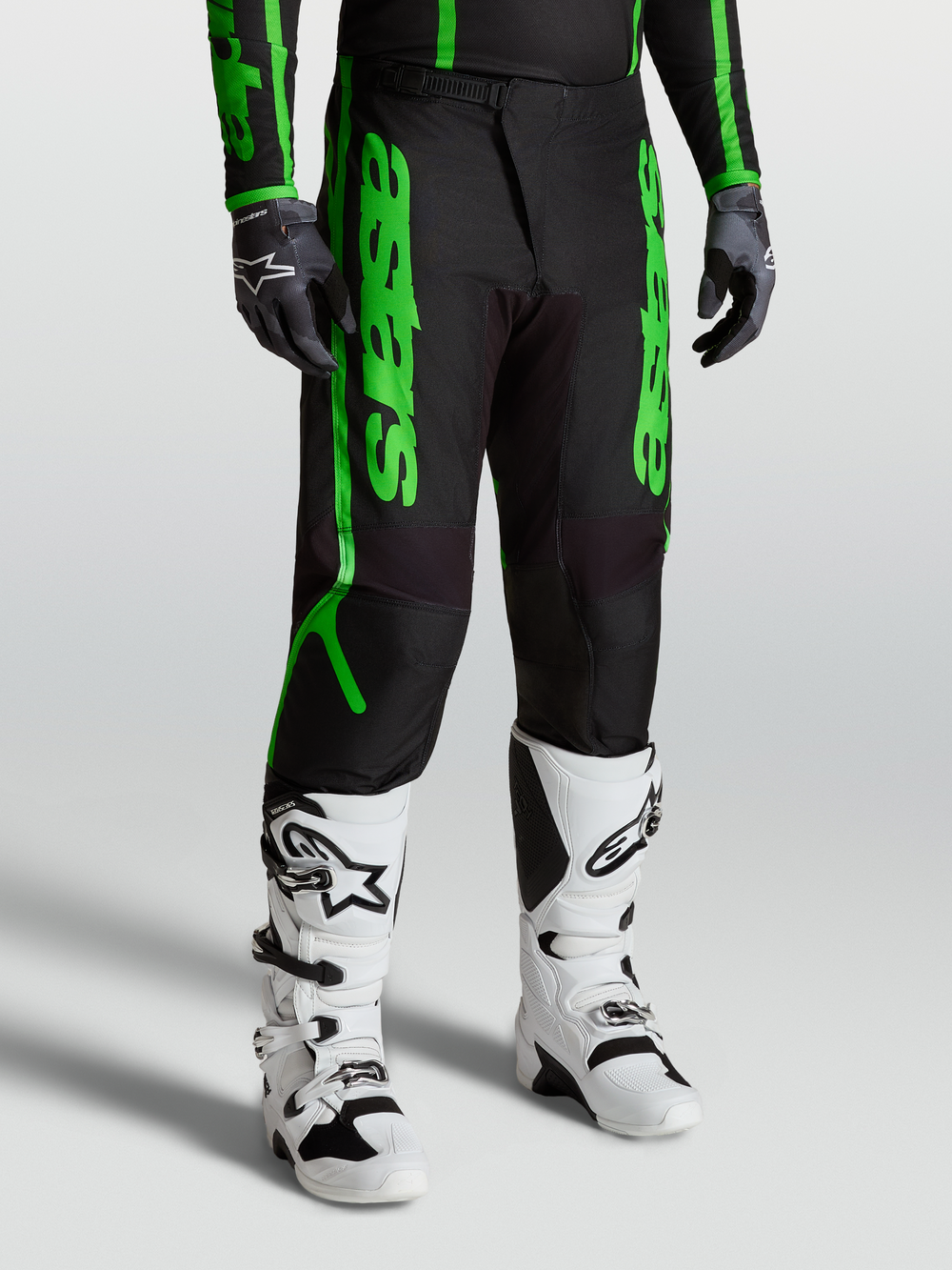 Alpinestars Fluid Apex V2 Pants, men's motocross performance gear in black and fluorescent green with reinforced 600D polyfabric.