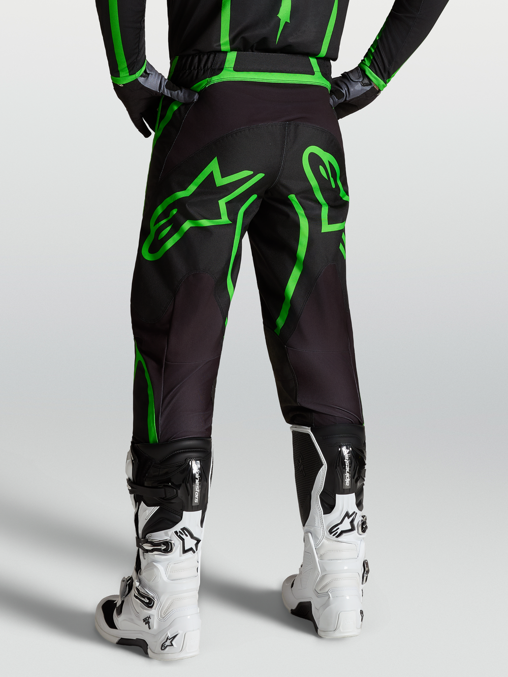 Alpinestars Fluid Apex V2 Pants, Men's Motocross and Off-Road Pants, Black and Green Fluo, Rear View on Model with White Boots.
