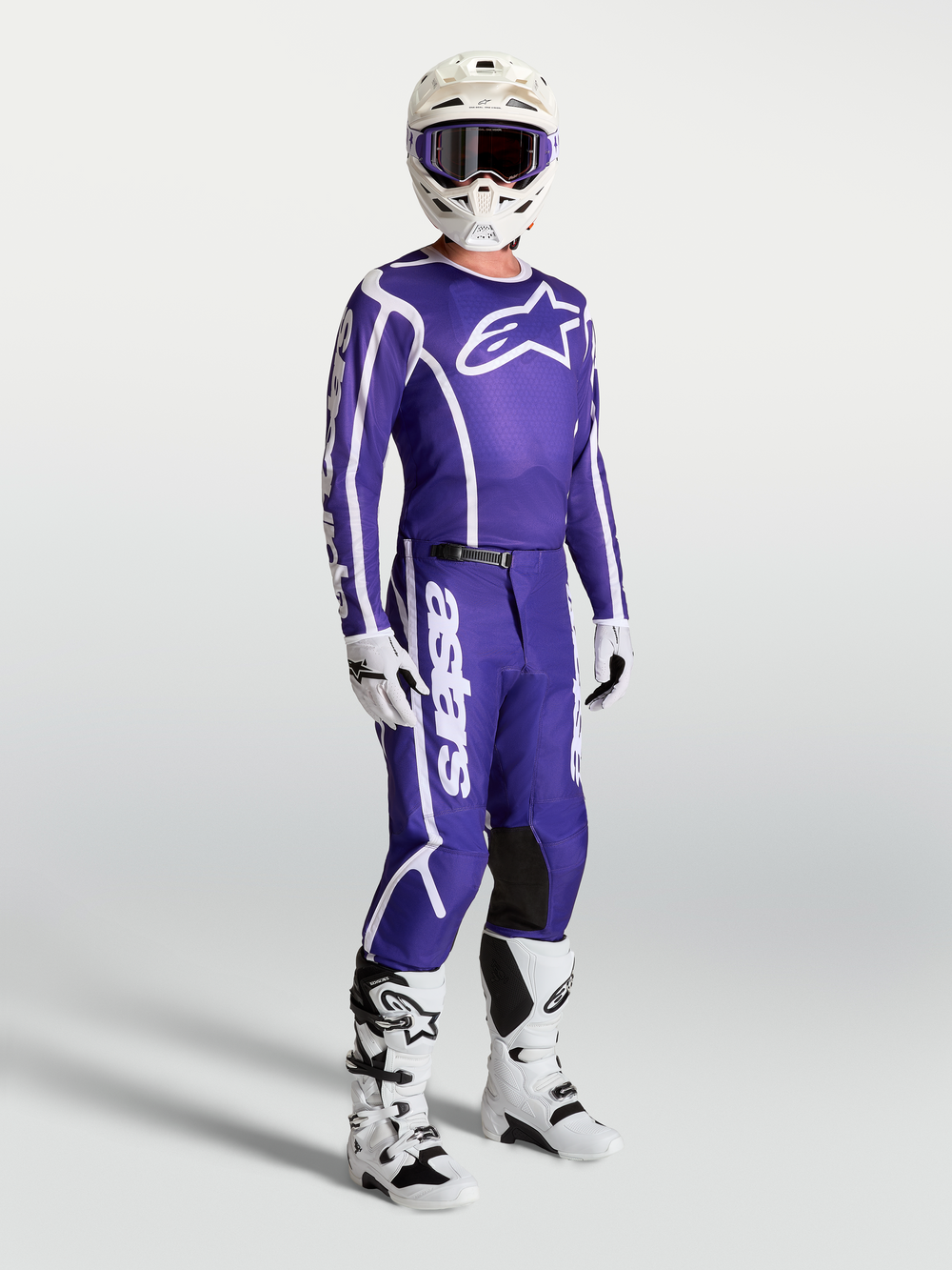 Alpinestars Fluid Apex V2 Jersey and matching pants, Deep Blue and White motocross gear set on-model with white boots and helmet.