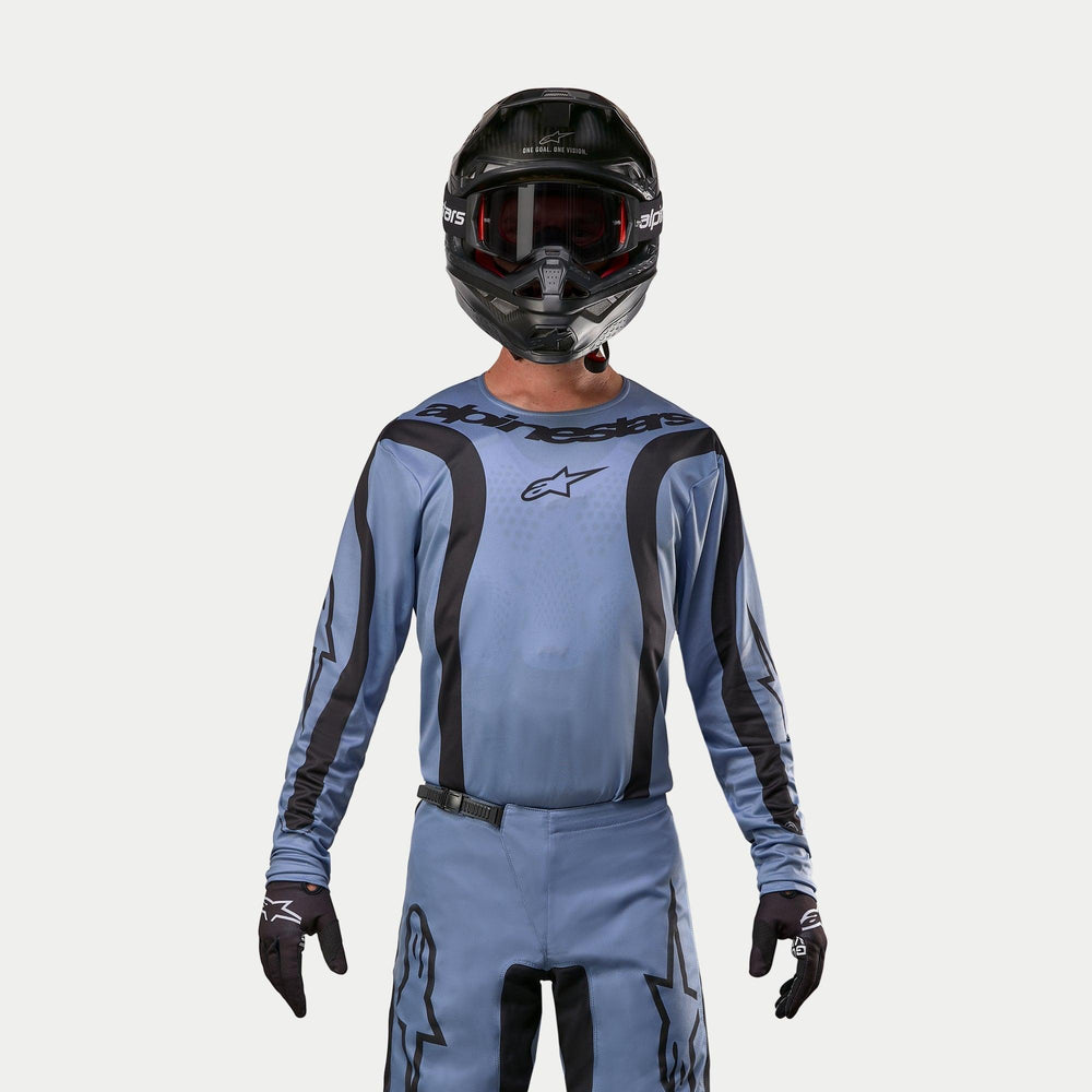 Alpinestars 2024 Fluid Lurv Jersey, Motocross Jersey, Light Blue and Black, worn by a rider with matching pants, black helmet with red goggles, and black gloves, coordinated outfit for off-road racing