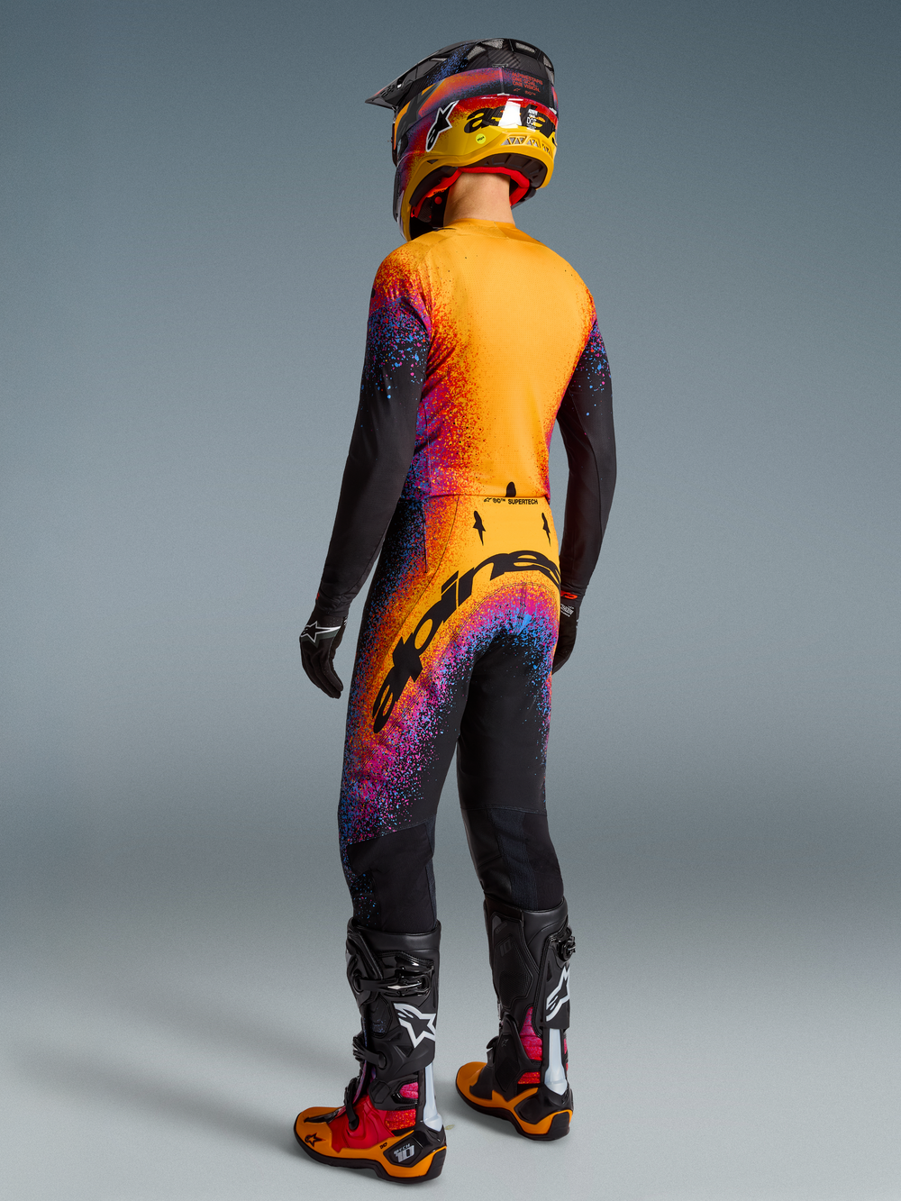 Alpinestars Limited Edition Supertech Black Hole Jersey and motocross gear set, black and orange-red cosmic design.