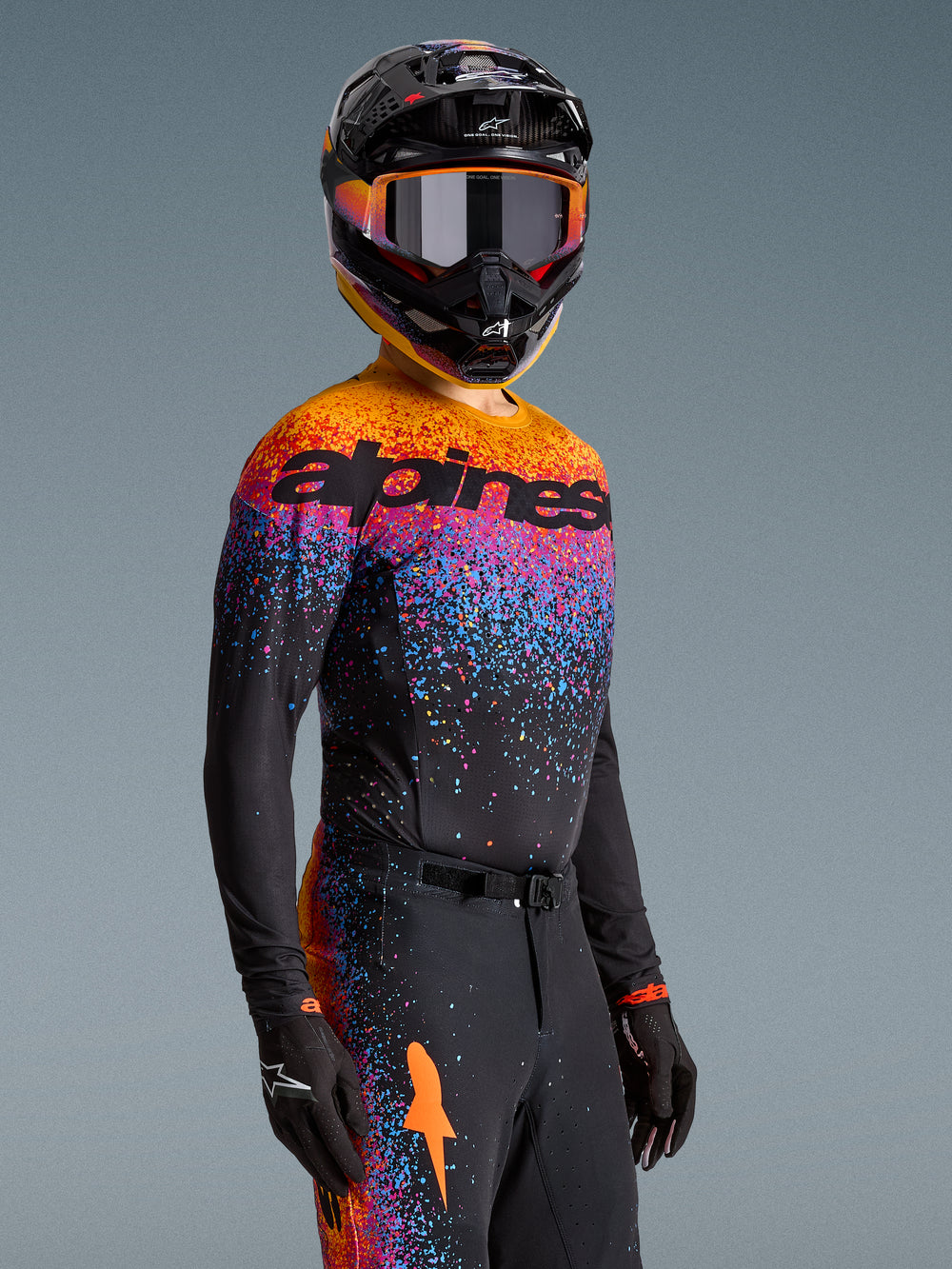 Alpinestars Limited Edition Supertech Black Hole Jersey, black motocross top with vibrant orange and purple cosmic graphics.