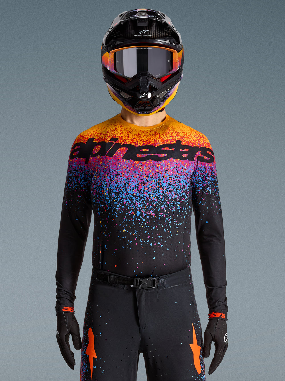 Alpinestars Limited Edition Supertech Black Hole Jersey, motocross racing jersey in black with vibrant orange and purple bursts.