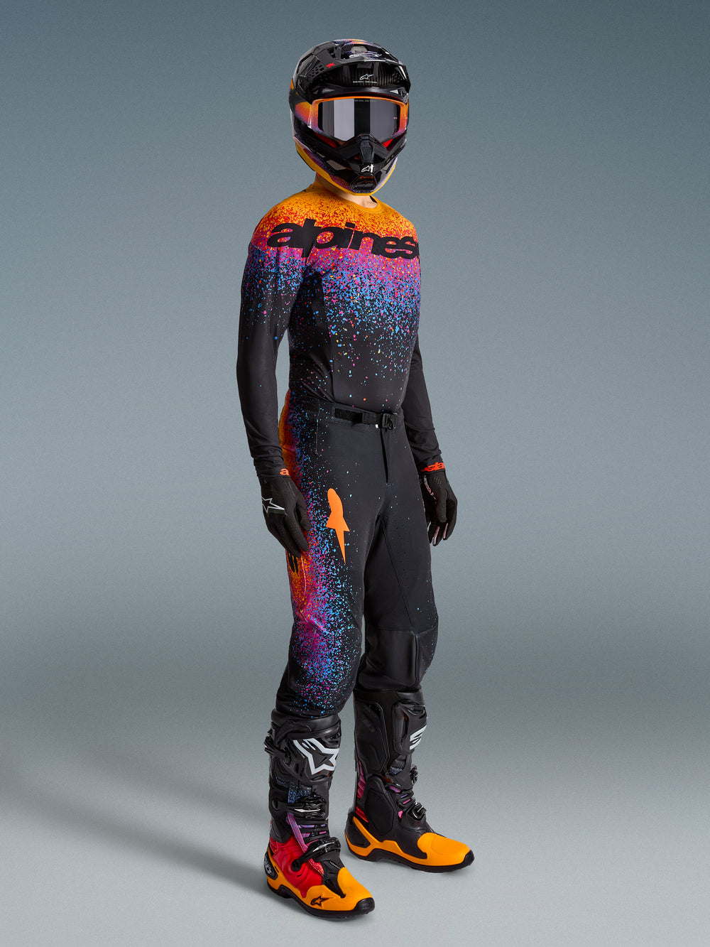 Alpinestars Limited Edition Supertech Black Hole Jersey, Motocross Racing Gear Set in Black with Orange and Purple Accents.