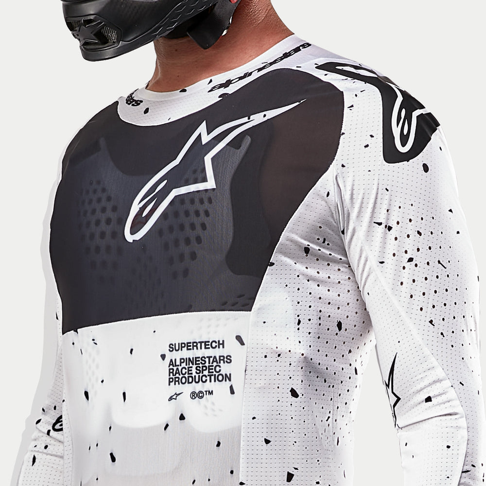 2024 Alpinestars Supertech Spek Jersey, White and Black Motocross Jersey with speckle pattern and breathable mesh panels.