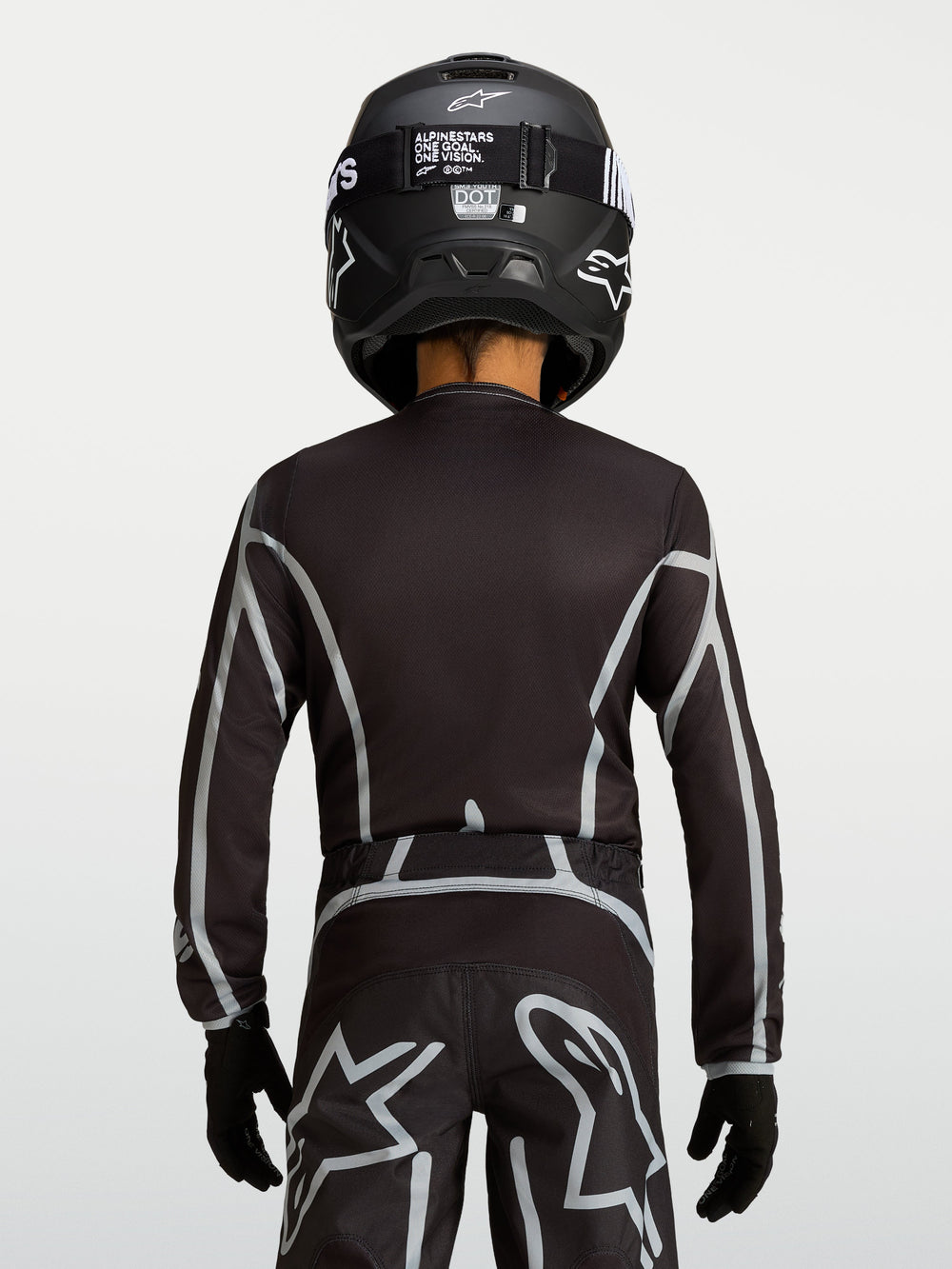 Alpinestars Youth Fluid Apex V2 Jersey, Black and Silver motocross top with ergonomic fit and extended rear coverage.