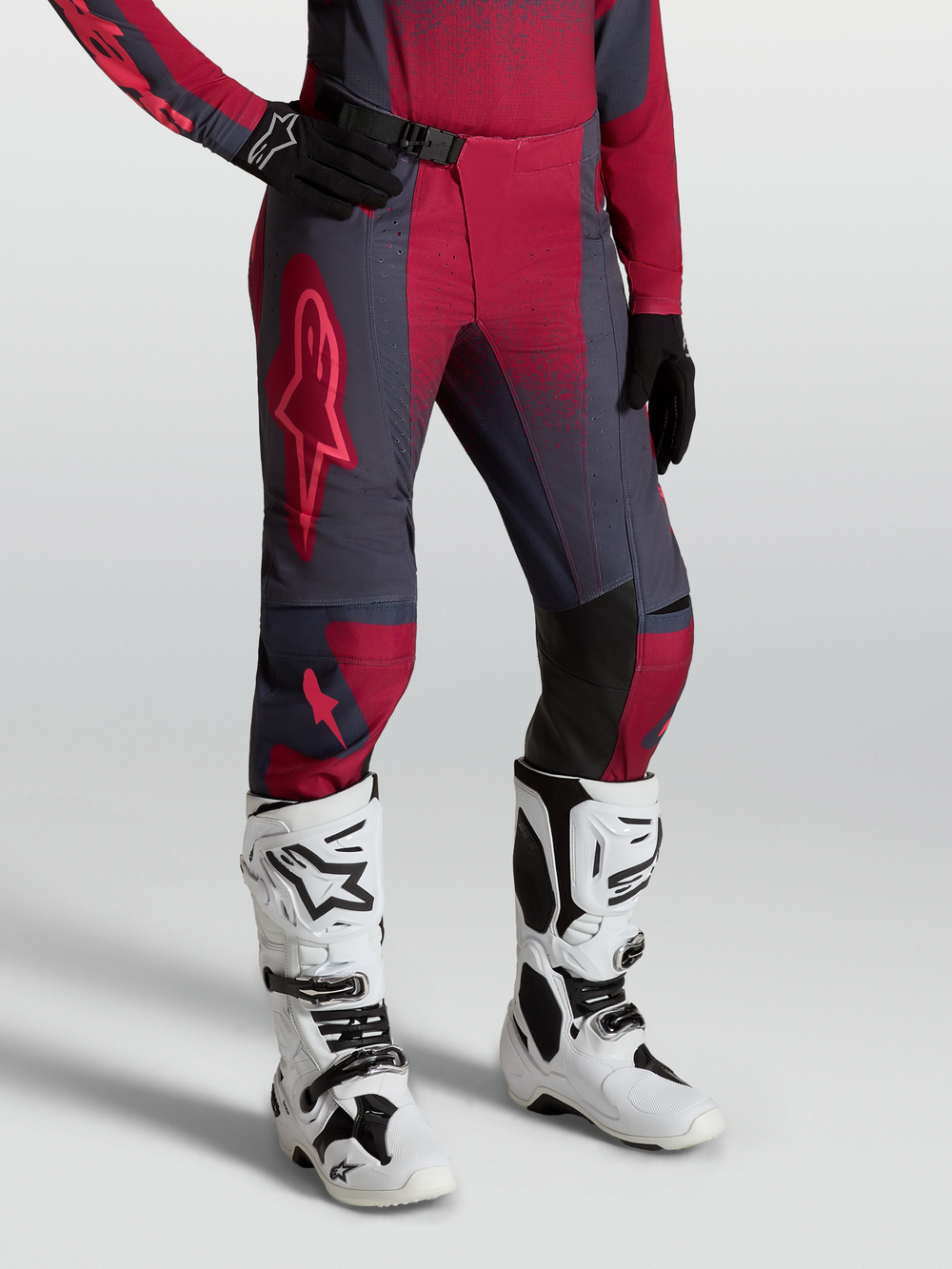 Alpinestars Stella Techstar Swan Pants, women's motocross gear, crimson and dark gray, worn with white Tech 10 boots.