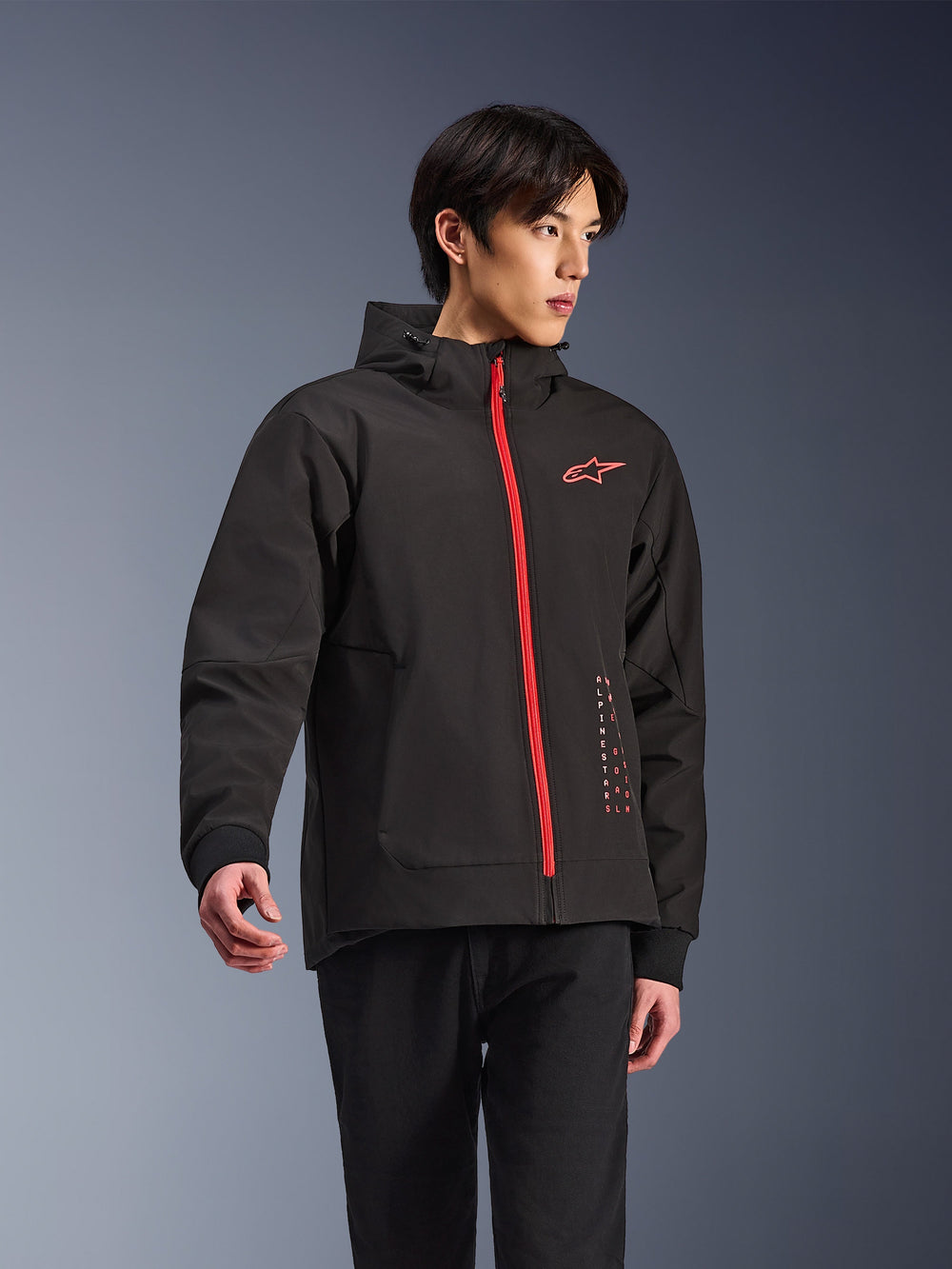 Alpinestars Radium Tech Hoodie, urban motorcycle jacket, Black with Bright Red zipper, featuring red Alpinestars logo on chest and red text on side, technical windproof shell with hood and ribbed cuffs, modern street style for riders