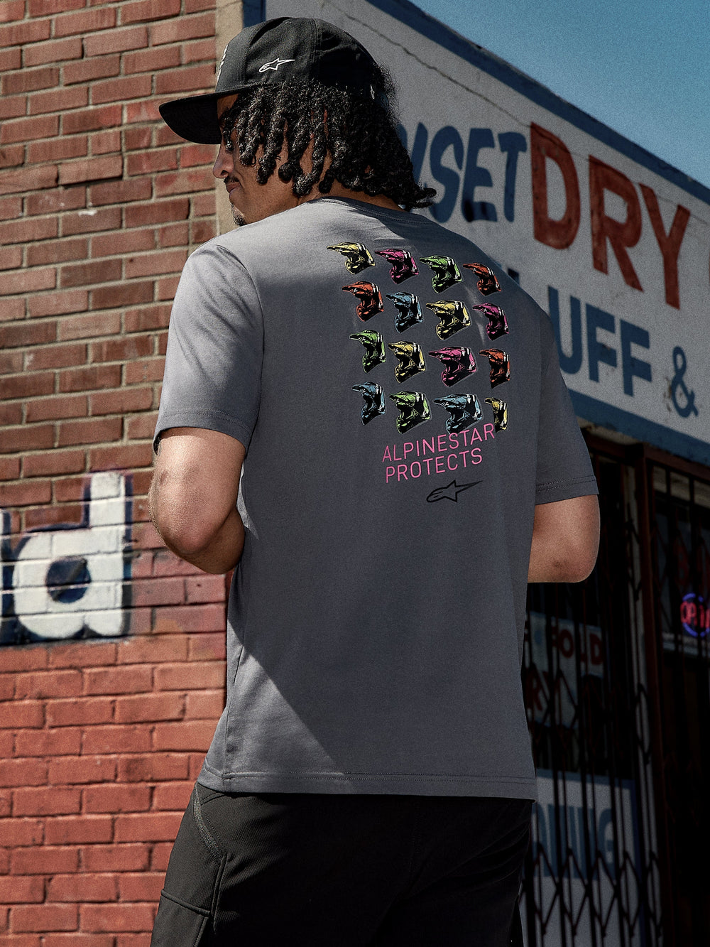 Alpinestars Pop Helmet CSF Tee, Short Sleeve T-Shirt, Charcoal Gray, back graphic featuring colorful M10 helmets and pink 