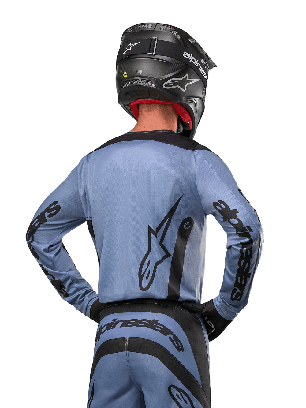Alpinestars 2024 Fluid Lurv Jersey, Motocross Jersey, Light Blue and Black, back view of rider showing large star logo and sleeve branding, worn with a black helmet and matching off-road pants, professional racing apparel