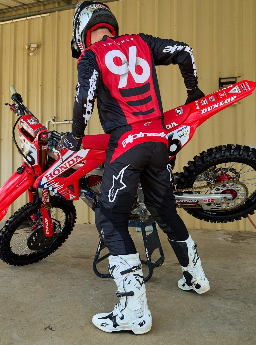Alpinestars 2025 Fluid Haul Gear Set, motocross jersey and pants, black and red, worn by rider 96 with dirt bike.