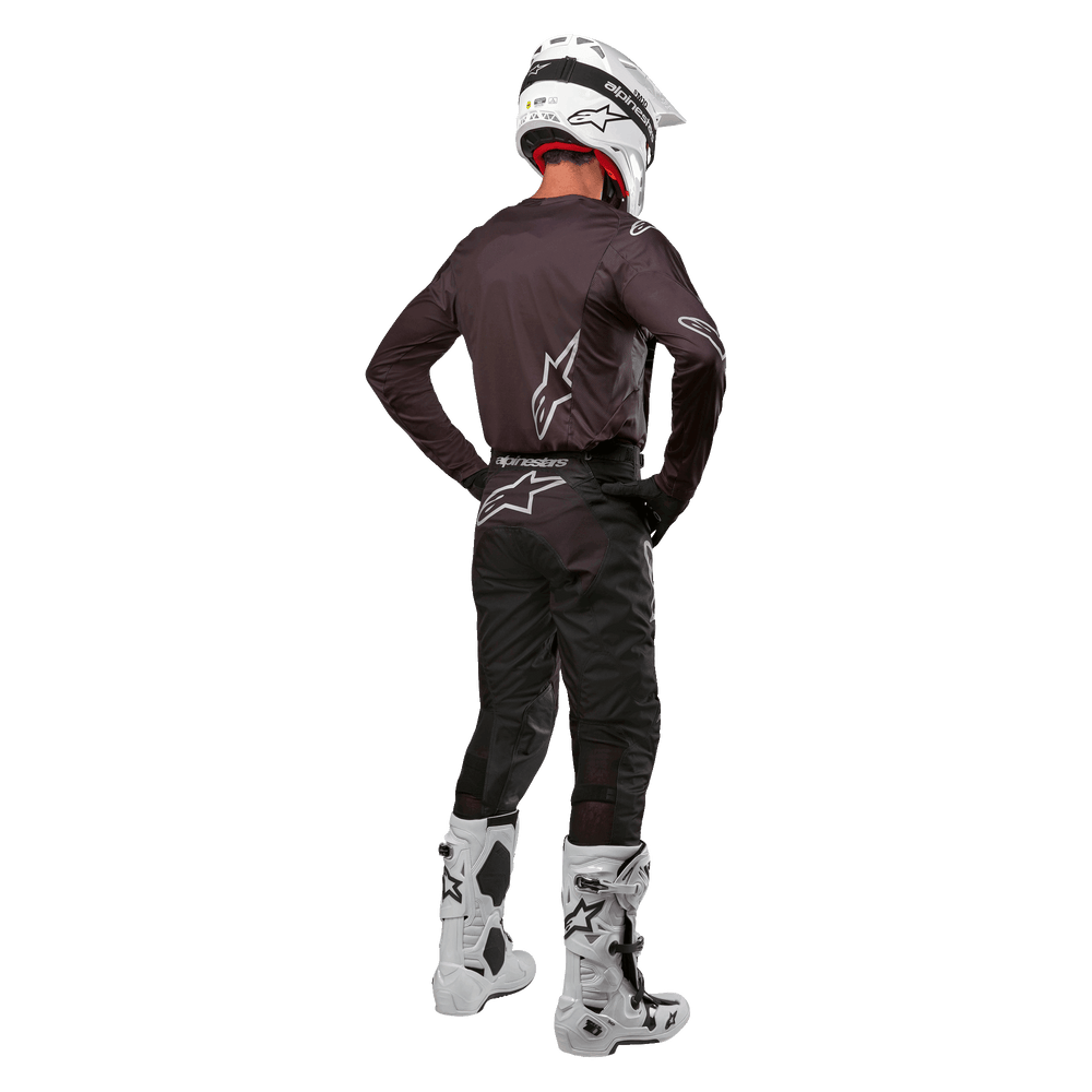 Alpinestars 2024 Racer Graphite Pants, black motocross pants, rear view on male model with white gear.